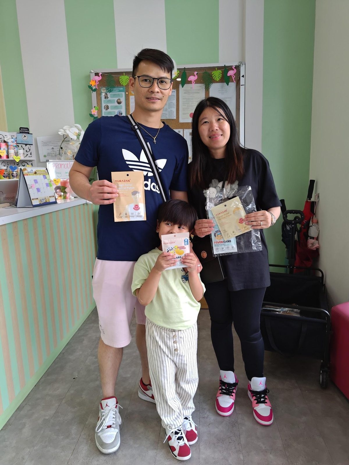 A family receives curated goodie bags at a clinic counter during a Nurture Circle activation